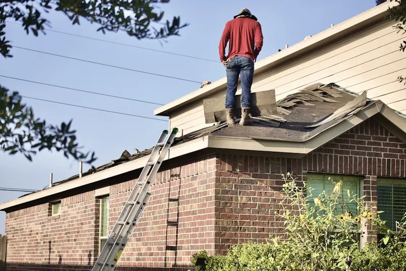 Professional roofer working on a residential roof in Sandy Hook